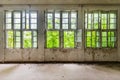 Interior of an old abandoned deserted and collapsing warehouse. Old rustic windows Royalty Free Stock Photo