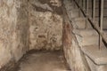 Interior of an old abandoned house with ruined walls and stairs