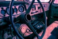 Interior of old abandoned truck, grunge background with rusty dashboard and driving wheel