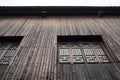 The interior of the old building. Chinese wooden wall with windows. Royalty Free Stock Photo