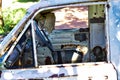 Interior of old car with the steering wheel and dashboard,Steering wheel inside an old rusted truck on the side of a highway