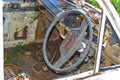 Interior of old car with the steering wheel and dashboard,Steering wheel inside an old rusted truck on the side of a highway.