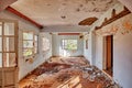 Interior of an old desolated house with white cracked walls and windows