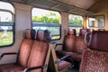 Interior of old european train with chairs in red