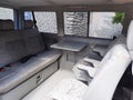 Interior of old luxury van with comfortable car passenger seat and table Royalty Free Stock Photo