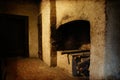 Interior of an old manor house with fireplace ready to light with logs, composition with digital texture added