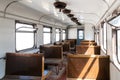 Interior of an old passenger car on a railroad. Historic vintage train Slightly left angle. Rows of seats and old style furnishing Royalty Free Stock Photo