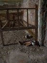 Interior of old prison cell with rusted bed and old rusted kitchenware Royalty Free Stock Photo