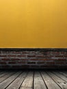 Interior of old red brick wall and yellow grunge cement wall with wooden flooring, Empty room template for display product. Royalty Free Stock Photo