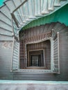 Interior of old renovated wooden square spiral staircase Royalty Free Stock Photo