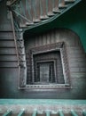 Interior of old renovated wooden square spiral staircase Royalty Free Stock Photo