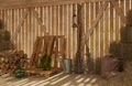 The Interior Of The Old Rural Barn With Bales Of Hay, Firewood, Tools For Work. Rays Of Light Through The Cracks Inside. 3D Visual