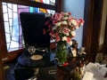 Interior in the old style of a restaurant or hotel with a gramophone and a bouquet of flowers Royalty Free Stock Photo