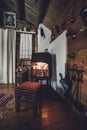 Interior in a old wooden cabin. By the fireplace