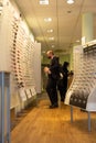 Interior of a optician store with costumers looking for spectacles.London