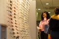 Interior of a optician store with costumers looking for spectacles.London