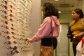 Interior of a optician store with costumers looking for spectacles.London