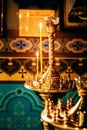 Interior of an Orthodox Ukrainian church. Burning candles on a gilded candlestick or candelabra