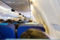 Interior of passenger airplane with people on seats Royalty Free Stock Photo