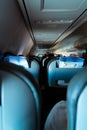 Interior of passenger airplane with people on seats Royalty Free Stock Photo