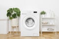 Interior of pastel colors laundry room with modern washing machine