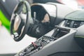 Interior photo of a Lamborghini sports car showing buttons and steering wheel