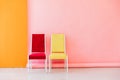 Interior of a pink room with colored chairs, armchairs