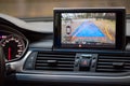 Interior of premium car with rearview camera dynamic trajectory turning lines and parking assistant steering wheel turned right.