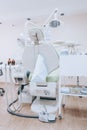 Interior of professionally equipped and modern design small dental office. Dental chair and other accessories used by dentists. Royalty Free Stock Photo