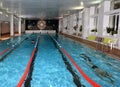 Interior public indoor swimming pool with vacationers people. Royalty Free Stock Photo