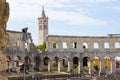 Interior of Pula Arena, the only remaining Roman amphitheatre entirely preserved, with the tower of the Church of St Anthony at