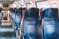 Interior of railway passenger car of the second class in train in Lombardy in Italy. Train interior. Blue seats in a commuter Royalty Free Stock Photo