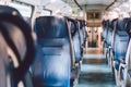 Interior of railway passenger car of the second class in train in Lombardy in Italy. Train interior. Blue seats in a commuter Royalty Free Stock Photo