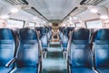 Interior of railway passenger car of the second class in train in Lombardy in Italy. Train interior. Blue seats in a commuter Royalty Free Stock Photo