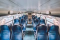 Interior of railway passenger car of the second class in train in Lombardy in Italy. Train interior. Blue seats in a commuter Royalty Free Stock Photo