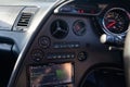 Interior of a rare Japanese sports car in the back of a gray Toyota Supra coupe with a dashboard, audio system, panel cockpit and