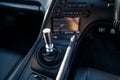 Interior of a rare Japanese sports car in the back of a gray Toyota Supra coupe with a dashboard, shift gear, audio system, panel