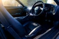 Interior of a rare Japanese sports car in the back of a gray Toyota Supra coupe with a dashboard, steering wheel, panel cockpit