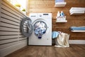 Interior of real laundry room with washing machine at window at Royalty Free Stock Photo