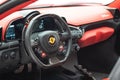 Interior of a red Ferrari 488 sports car with a digital display illuminated in the dashboard Royalty Free Stock Photo