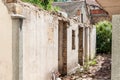 Interior remains of hurricane or earthquake disaster damage on ruined old house in the city with collapsed walls, roof and bricks