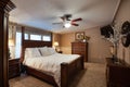 Interior of a renovated bedroom with a wooden bed and three vintage chests of drawers