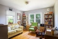 Interior of a renovated furnished living-room with two windows