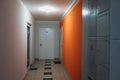 Interior of a residential building in white and orange colors with entrance doors Royalty Free Stock Photo