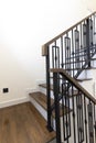 Interior of residential house or hotel. Contemporary wooden stairs with forged rails.