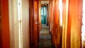 Beautiful interior of retro steam train car with wooden doors and carpets on floor Royalty Free Stock Photo