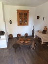 The interior of a Romanian country house. Kitchen with stove, cupboard and table having clay plates and wooden spoons