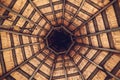 Interior roof beams in wooden gazebo. Architectural design and framing of a gazebo