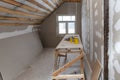 Interior of room apartment with new window and materials home-made scaffold, tools, level during on the renovation, overhaul and