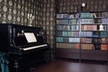 Interior of room with book shelves and piano